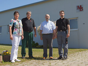 Mitarbeiterteam vor Firmengebäude